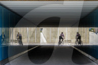 Cyclist Rides Through The Mirrored Interior Of A Tunnel
