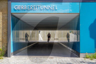 Cyclist Rides Through The Mirrored Interior Of A Tunnel