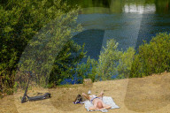 Man Sunbathing By The Moselle River