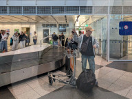 Travelers At A Baggage Carousel At Munich Airport