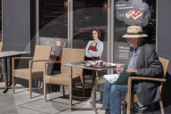 Senior Citizen Seated At Outdoor Café