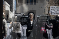 Protesters Demonstrate Outside Elite Law Firm Over Deal With Trump 