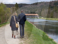 Couple Walking Along The Isar Canal In The District Of Munich