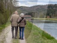 Couple Walking Along The Isar Canal In The District Of Munich