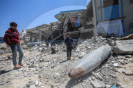Gazans in tents near military remnants