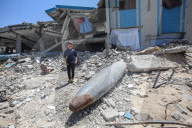 Gazans in tents near military remnants