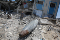 Gazans in tents near military remnants