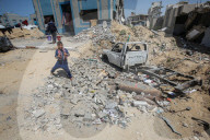 Gazans in tents near military remnants