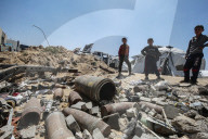 Gazans in tents near military remnants