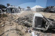 Gazans in tents near military remnants