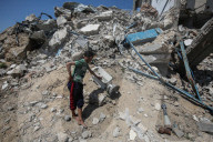 Gazans in tents near military remnants