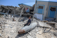 Gazans in tents near military remnants