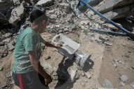 Gazans in tents near military remnants