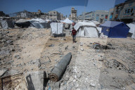 Gazans in tents near military remnants