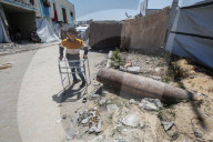 Gazans in tents near military remnants