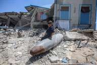 Gazans in tents near military remnants