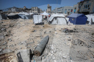 Gazans in tents near military remnants