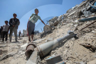 Gazans in tents near military remnants