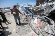 Gazans in tents near military remnants