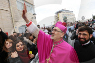 Pierbattista Pizzaballa, the Latin Patriarch of Jerusalem, greets people as he arrives to attend Christmas celebrations in Bethlehem, in the West Bank