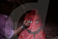 Priest Giving Final Touch Paint On Statue Of Idol Rato Machindranath In Nepal 