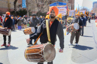 Sikh Men Play A Rhythmic Tune On The Dhol During Vaisakhi