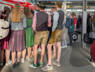 Travelers In Traditional Bavarian Clothing On A Platform At Munich Central Station