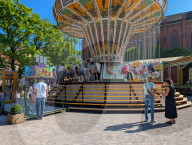 Visitors Enjoy The Auer Dult Fair At Mariahilfplatz In Munich