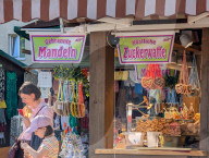 Visitors Enjoy The Auer Dult Fair At Mariahilfplatz In Munich
