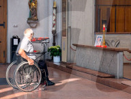Man In Wheelchair Prays Before Memorial Of Pope Francis In Catholic Church