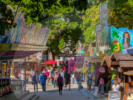 Visitors Enjoy The Auer Dult Fair At Mariahilfplatz In Munich