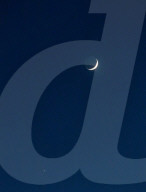 A Crescent Moon Visible With Jupiter In Linköping, Sweden.