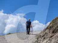 Senior And Child Hiking Together