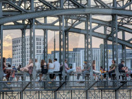 Evening Crowd Sits On Hackerbruecke In Munich