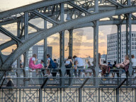 Evening Crowd Sits On Hackerbruecke In Munich