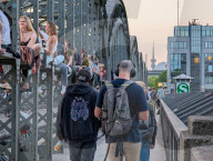 Evening Crowd Sits On Hackerbruecke In Munich
