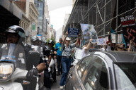 Protesters Rally At Tesla Dealership And March To Billionaires’ Offices In Manhattan