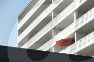 Red Umbrella Shades A Sunlit Balcony On A Late Summer Day