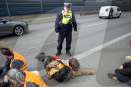 Activists Block Highway By Glueing Their Hands In Warsaw