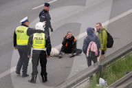 Activists Block Highway By Glueing Their Hands In Warsaw