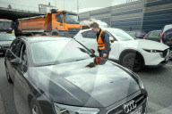 Activists Block Highway By Glueing Their Hands In Warsaw