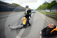 Activists Block Highway By Glueing Their Hands In Warsaw