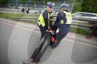 Activists Block Highway By Glueing Their Hands In Warsaw
