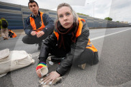 Activists Block Highway By Glueing Their Hands In Warsaw