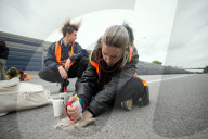 Activists Block Highway By Glueing Their Hands In Warsaw