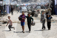 Displaced Gazans take refuge in tents and damaged schools