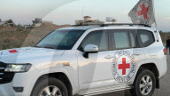 Red Cross vehicles carrying Israeli American hostage Idan Alexander at border crossing