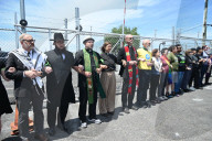 Faith Clergy Forms Human Chain To Block Entrances And Exits To Delaney Hall ICE Immigration Detention Facility