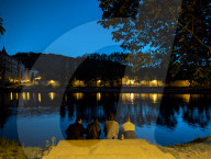 Daily Life By The Riverbank At Vltava River In Prague At Night