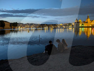 Daily Life By The Riverbank At Vltava River In Prague At Night